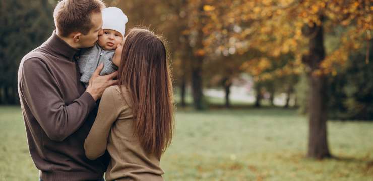 Young family with baby son in park